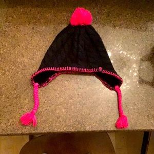 This a North Face winter hat. Pom-Pom at the top, and braids on either sides.